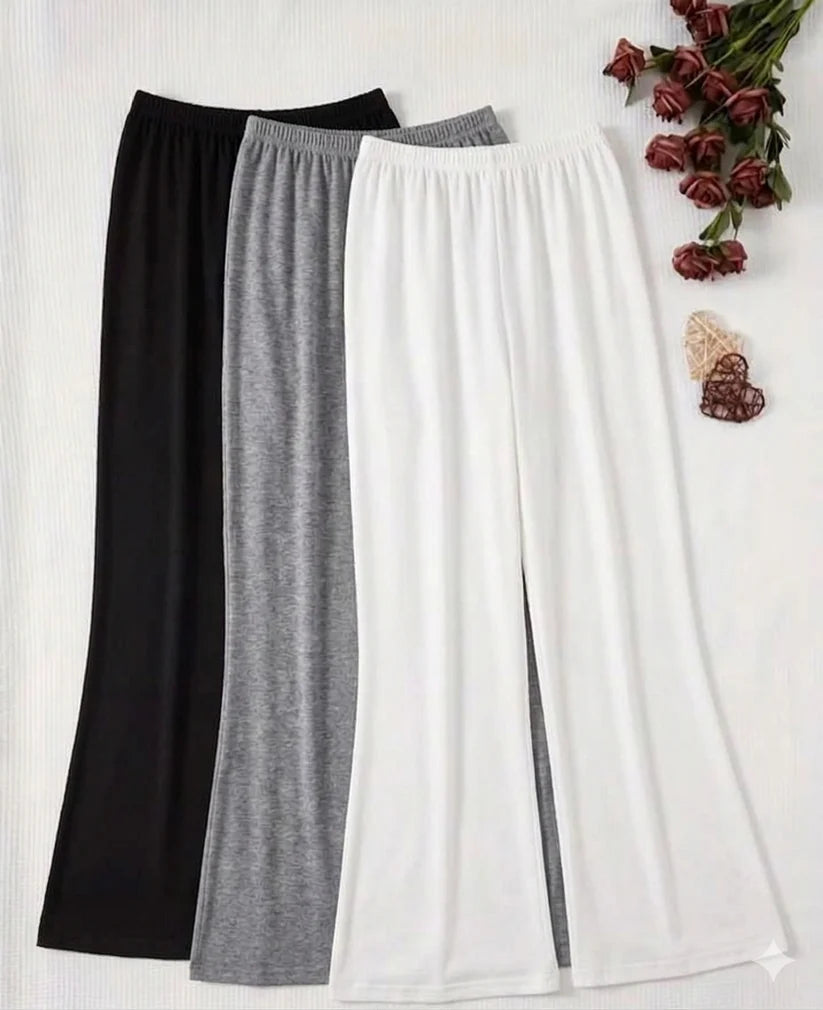 Three pairs of pants in black, gray, and white on a white background with decorative elements.