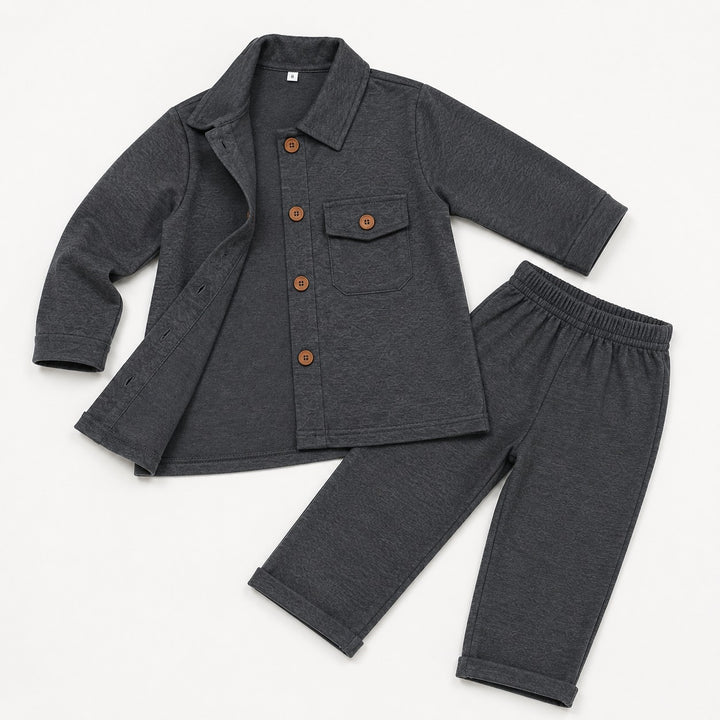 A two-piece toddler clothing set in dark heather gray, featuring a long-sleeve button-front shirt jacket with a chest pocket and matching elastic-waist pants, laid flat on a white background.